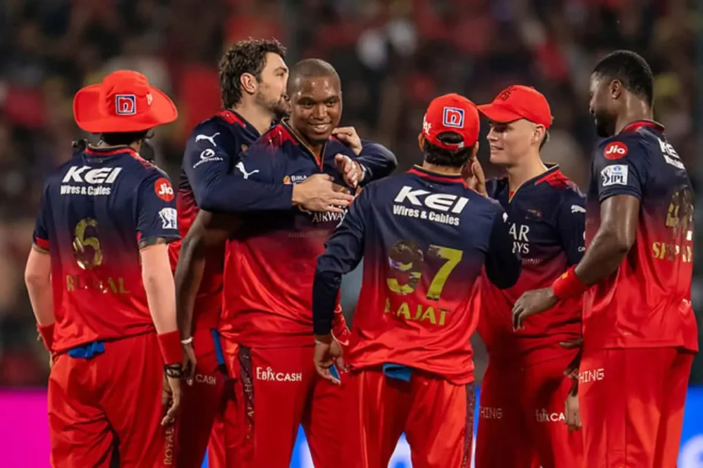 RCB players celebrating a wicket during an IPL match, showcasing Royal Challengers Bangalore team spirit and on-field performance.